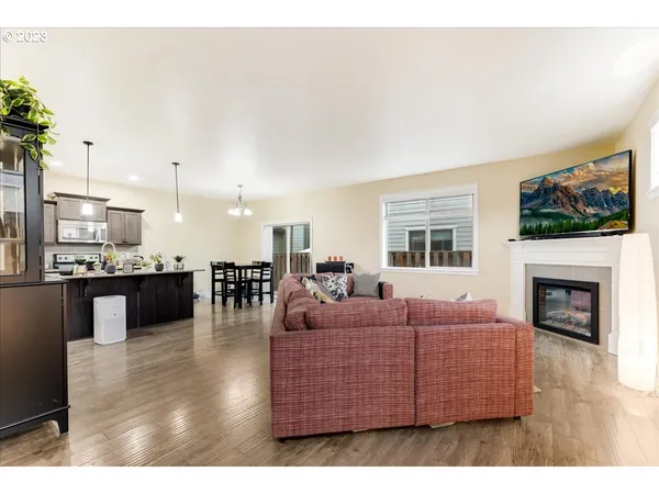 a living room with furniture a flat screen tv and a fireplace