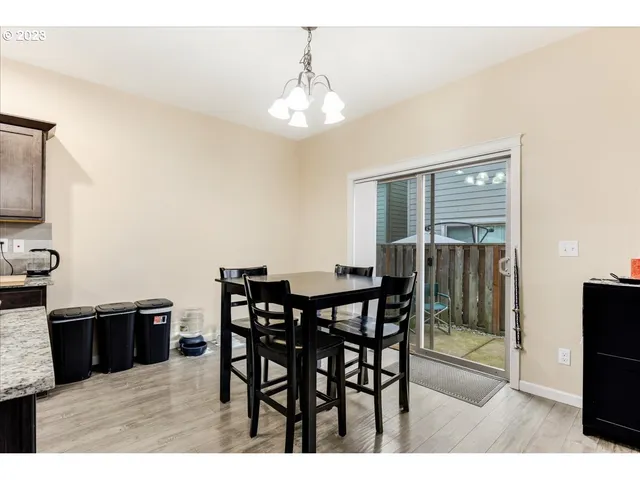 a view of a dining room with furniture and chandelier