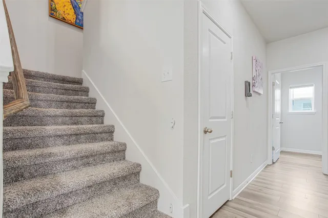 a view of an entryway with paintings on the wall