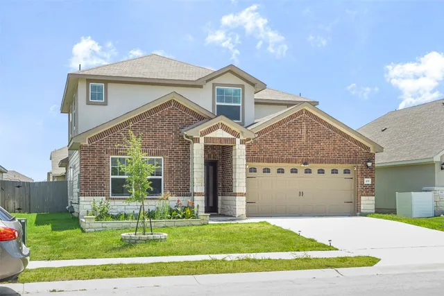 a front view of a house with a yard