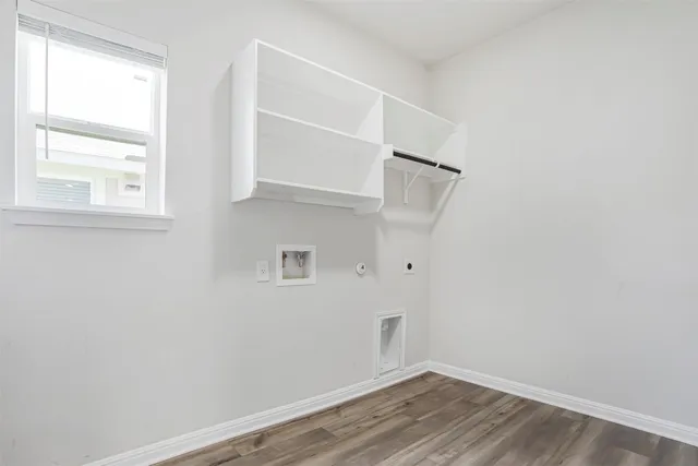 a kitchen with white cabinets and refrigerator