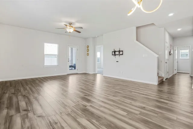 a kitchen with a sink stove and wooden floor