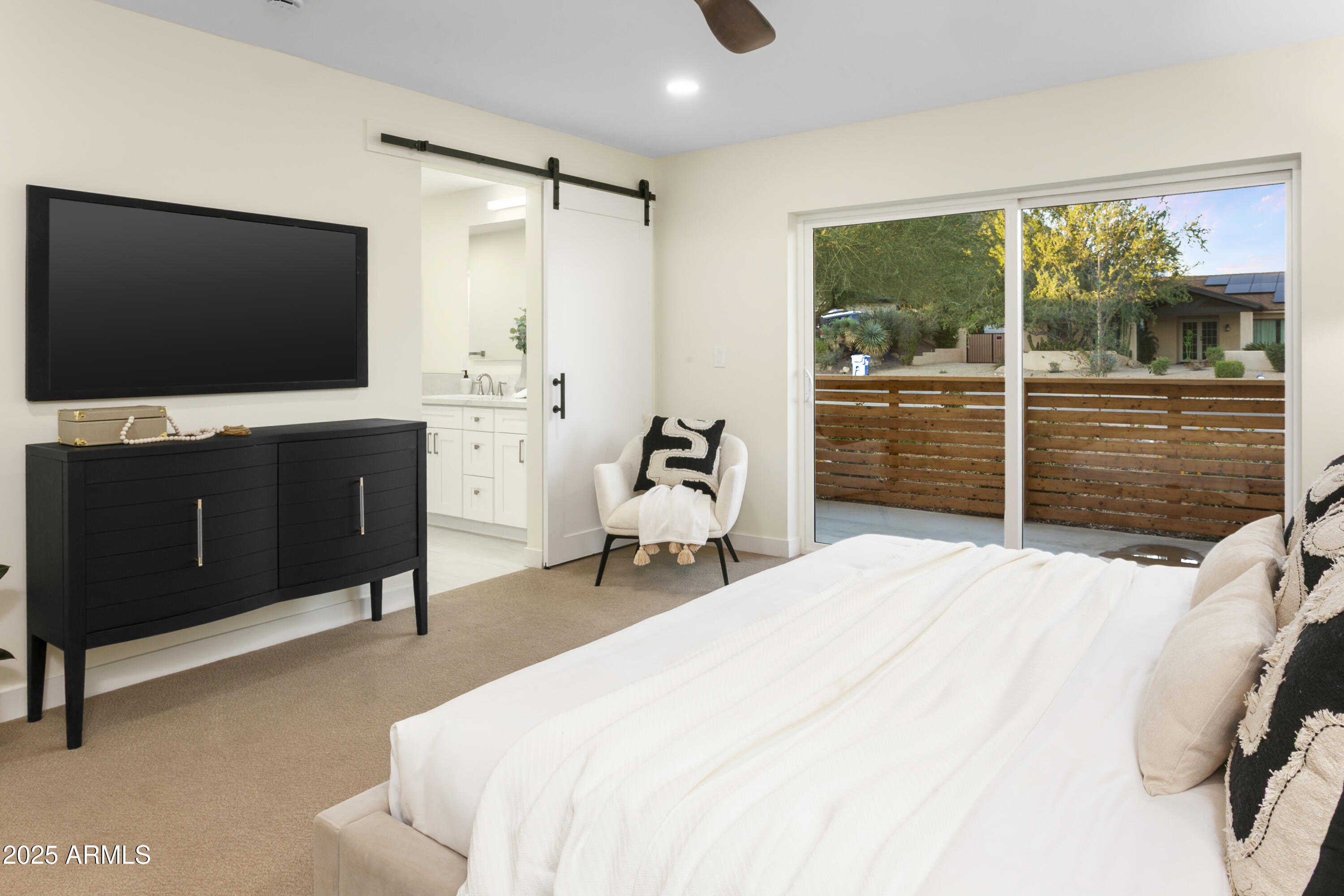 2273 East Clinton Street Phoenix, AZ 85028 - Photo 13 of 30 a bedroom with a bed and a flat tv screen on dresser