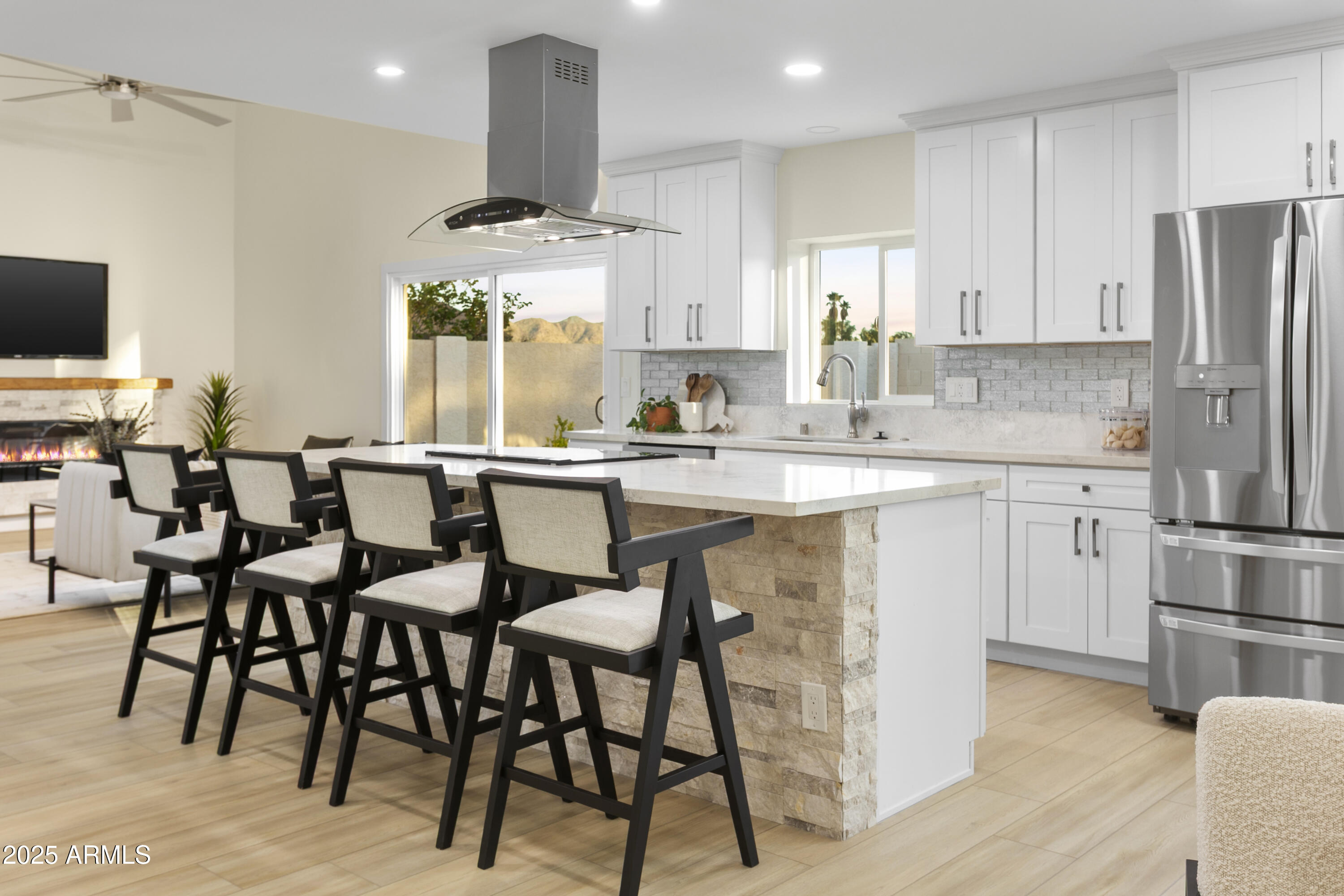 2273 East Clinton Street Phoenix, AZ 85028 - Photo 3 of 30 a kitchen with stainless steel appliances kitchen island granite countertop a table chairs sink and cabinets