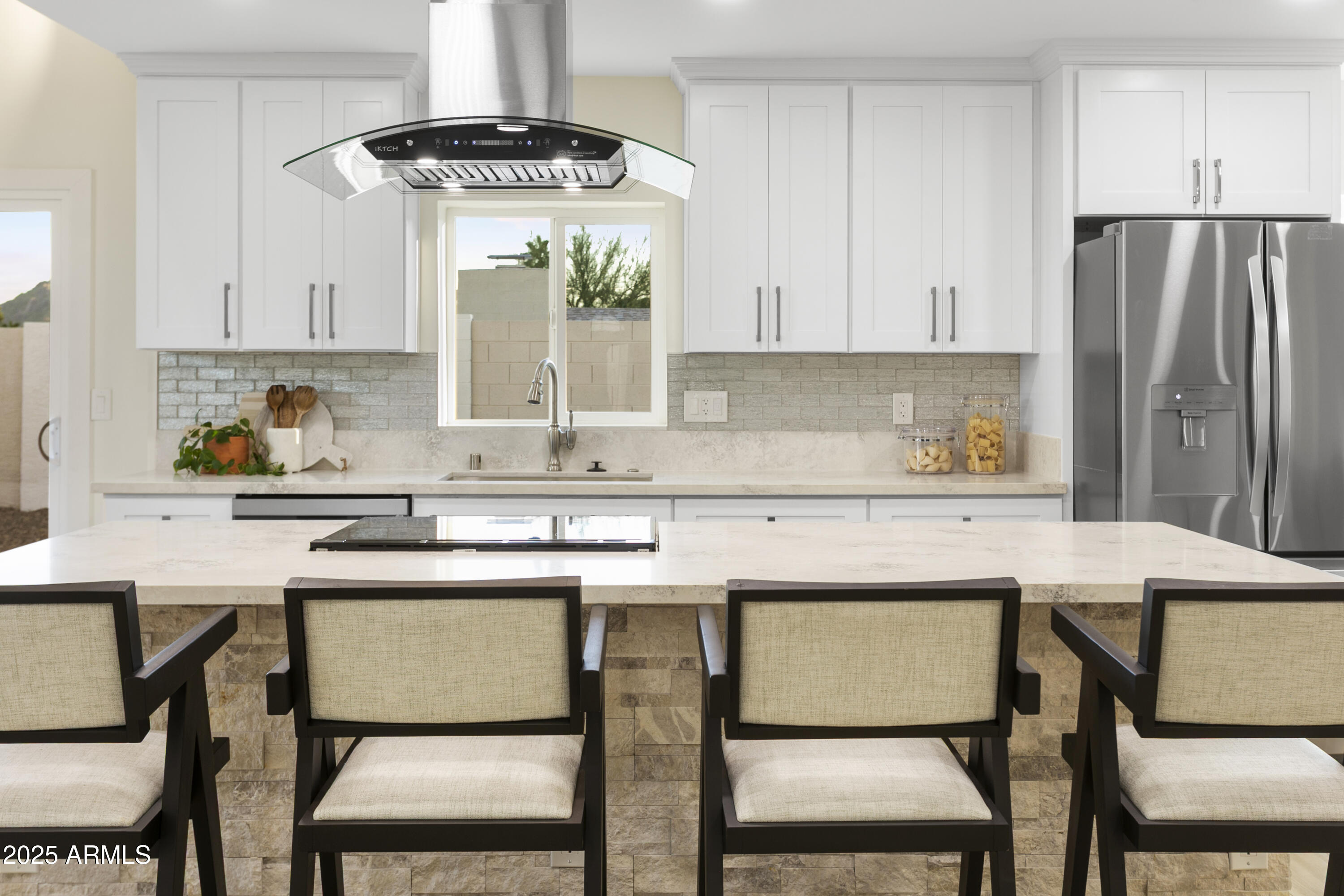 2273 East Clinton Street Phoenix, AZ 85028 - Photo 4 of 30 a kitchen with a table chairs refrigerator and cabinets