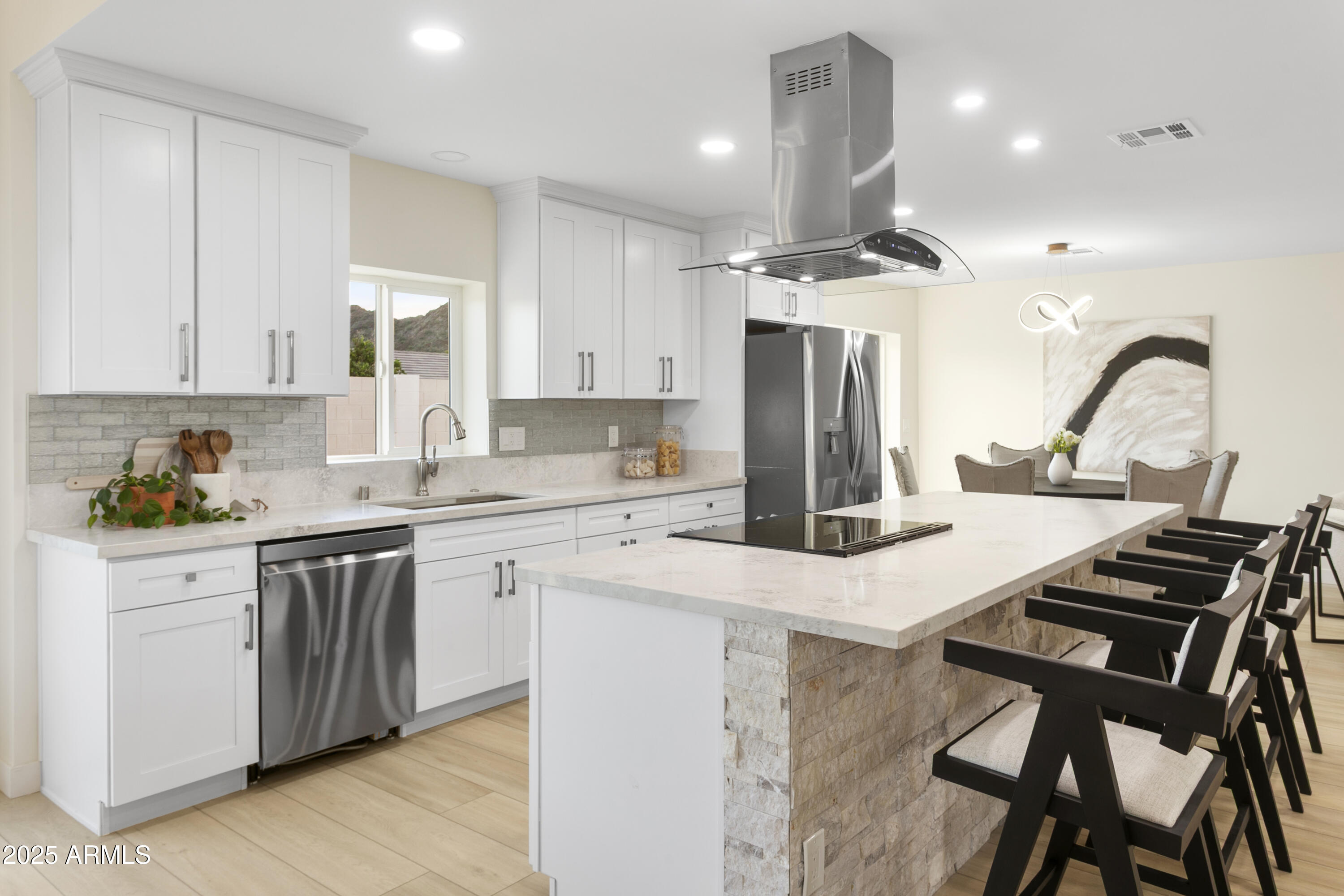 2273 East Clinton Street Phoenix, AZ 85028 - Photo 5 of 30 a kitchen with kitchen island granite countertop a stove a sink dishwasher a refrigerator and white cabinets with wooden floor
