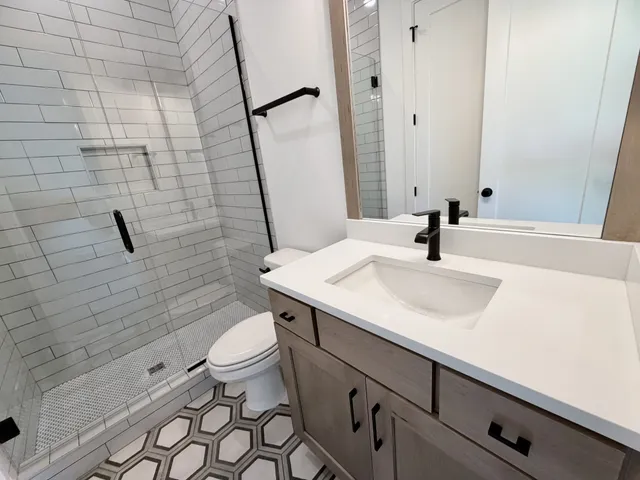 an empty room with a ceiling fan and window