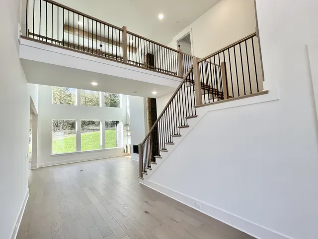 a view of a kitchen with a sink wooden cabinets and a window