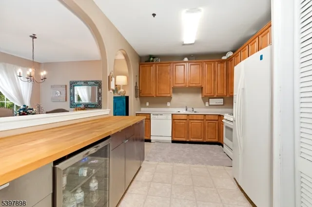 a large kitchen with kitchen island a large counter space a sink stainless steel appliances and cabinets
