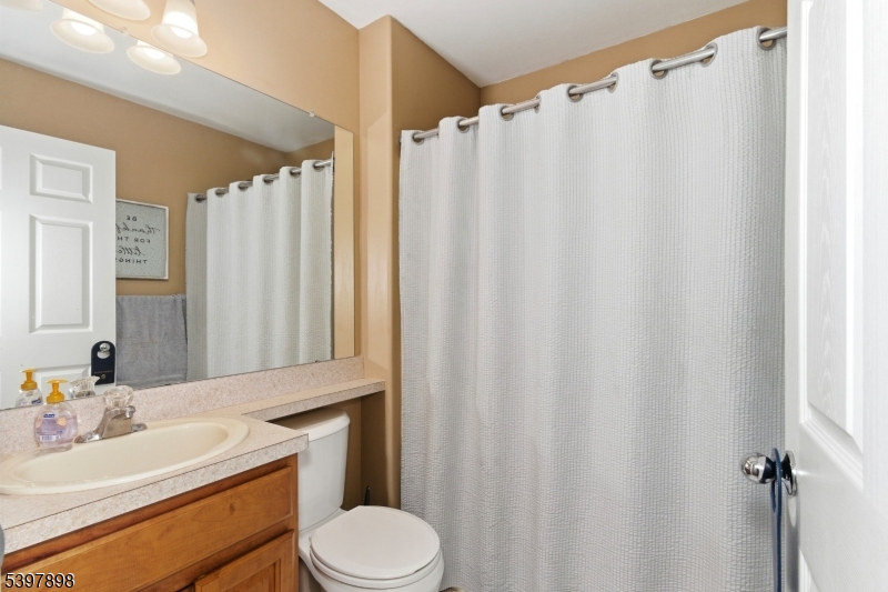 106 Limerick Lane Phillipsburg, NJ 08865 - Photo 17 of 23 a bathroom with a sink a toilet and shower curtain