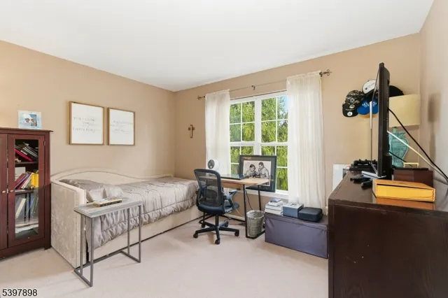 a bedroom with furniture and a window