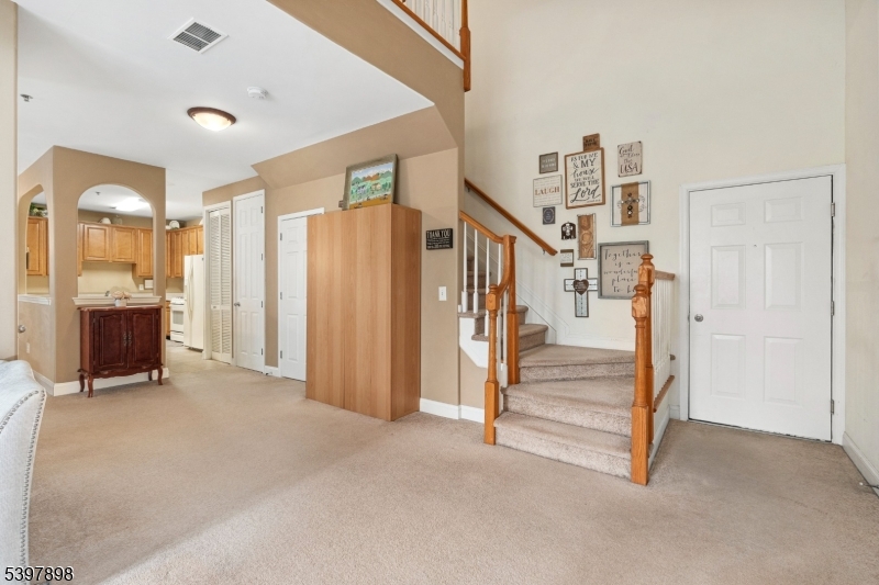 106 Limerick Lane Phillipsburg, NJ 08865 - Photo 5 of 23 an empty room with staircase and a ceiling fan