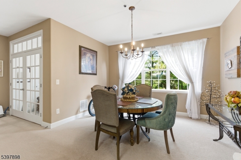 106 Limerick Lane Phillipsburg, NJ 08865 - Photo 7 of 23 a dining room with furniture a chandelier and wooden floor