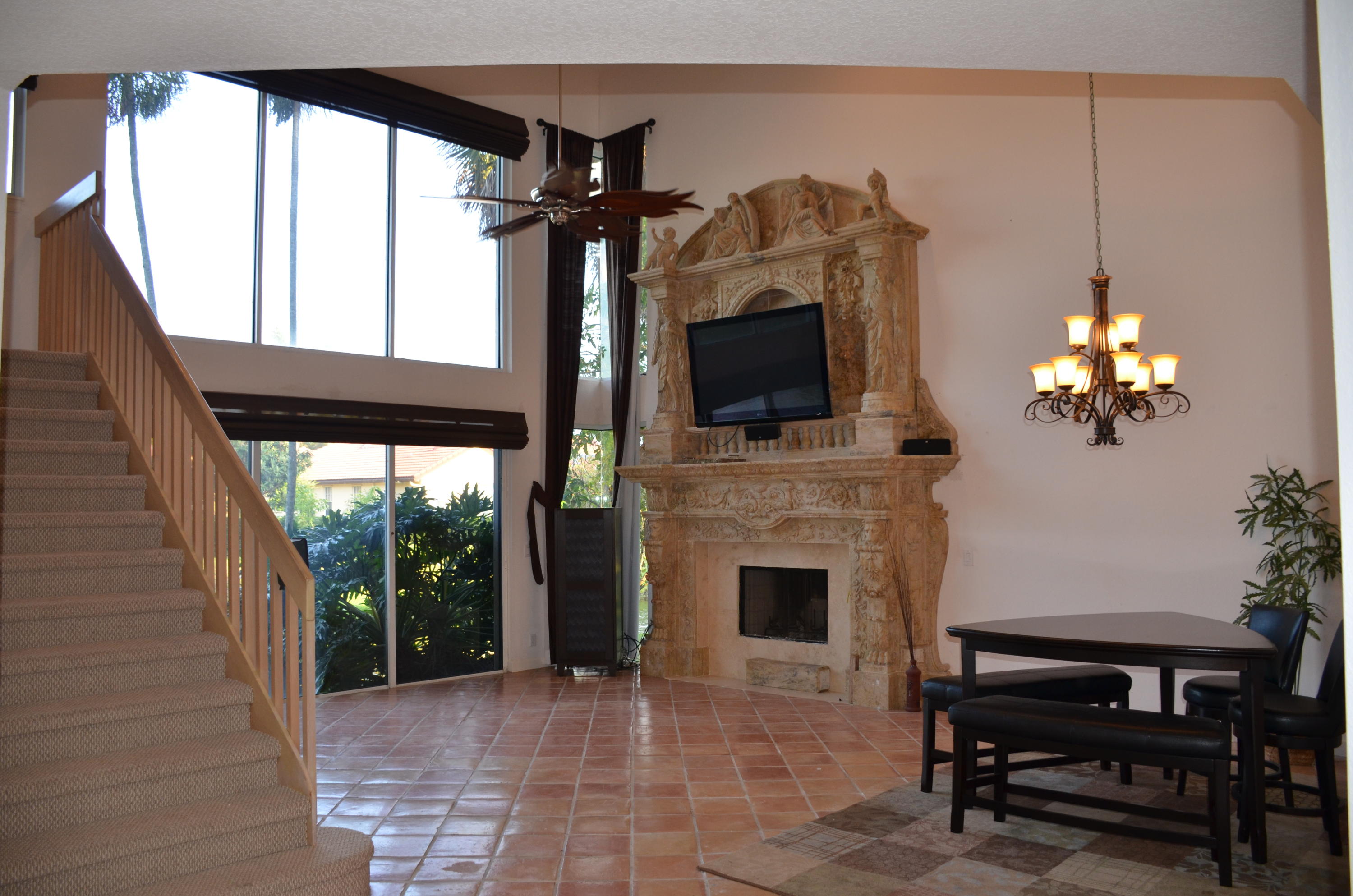 1200 Parkside Avenue Boca Raton, FL 33486 - Photo 18 of 33 a living room with furniture a fireplace and a flat screen tv
