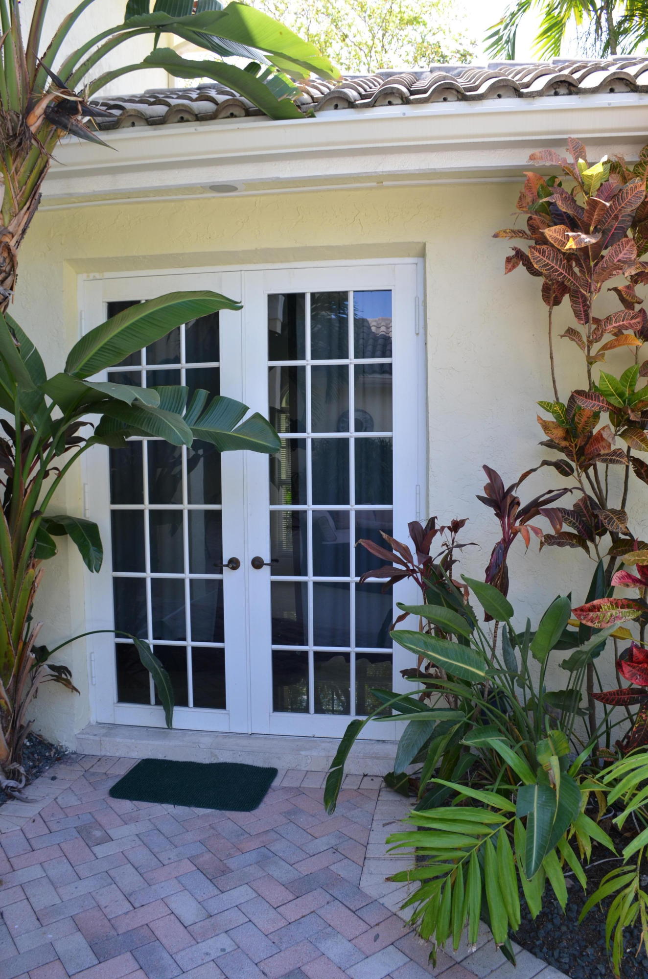 1200 Parkside Avenue Boca Raton, FL 33486 - Photo 10 of 33 a front view of a house with a large window and a potted plant