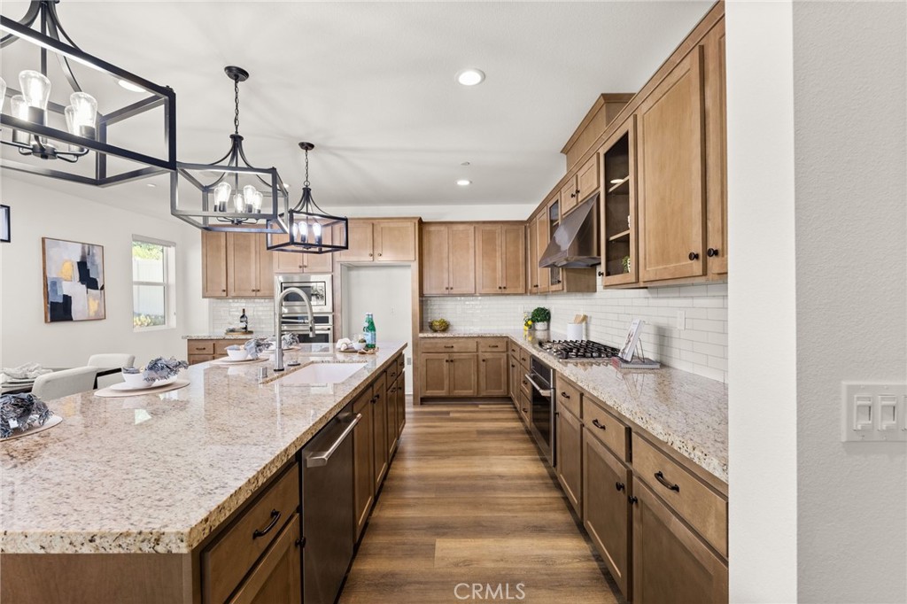 32448 Toyon Road Temecula, CA 92591 - Photo 12 of 72 a large kitchen with kitchen island granite countertop a sink and cabinets