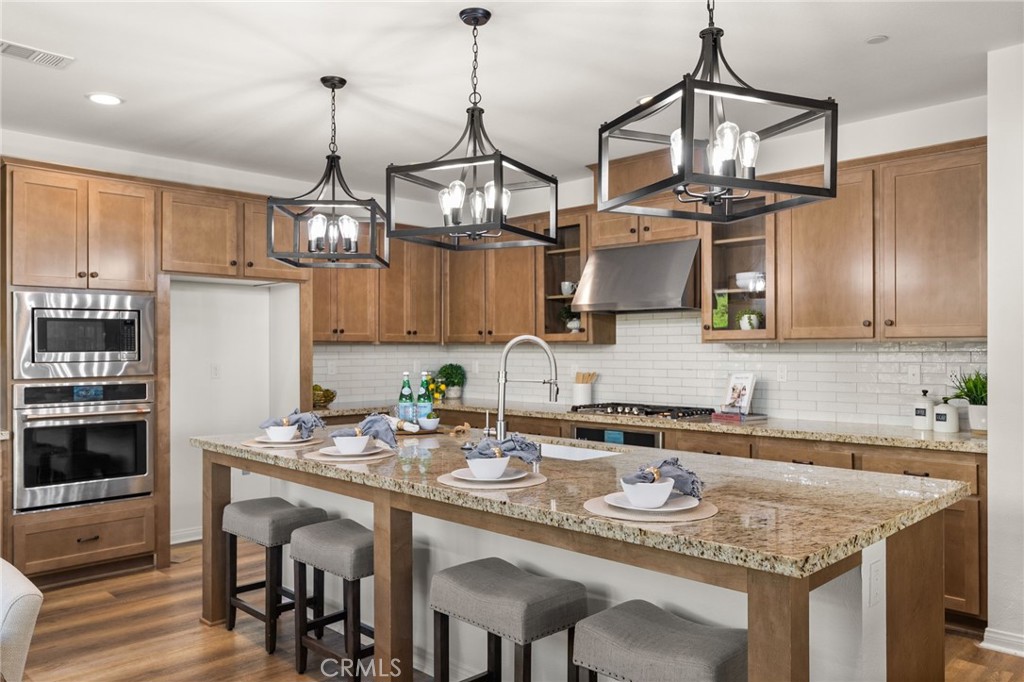 32448 Toyon Road Temecula, CA 92591 - Photo 16 of 72 a kitchen with stainless steel appliances granite countertop a sink a stove and chairs