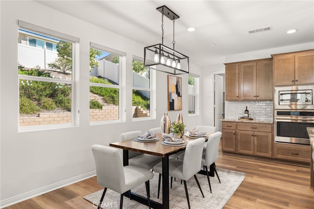32448 Toyon Road Temecula, CA 92591 - Photo 17 of 72 a view of a dining room with furniture window and wooden floor