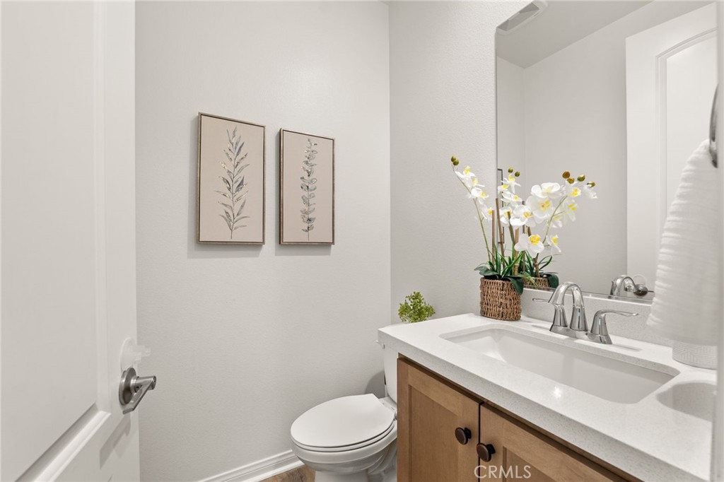 32448 Toyon Road Temecula, CA 92591 - Photo 19 of 72 a bathroom with a granite countertop toilet sink and mirror