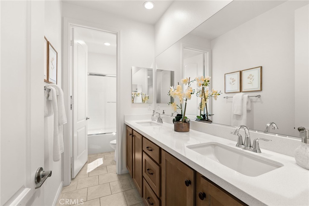 32448 Toyon Road Temecula, CA 92591 - Photo 30 of 72 a bathroom with a double vanity sink mirror and shower