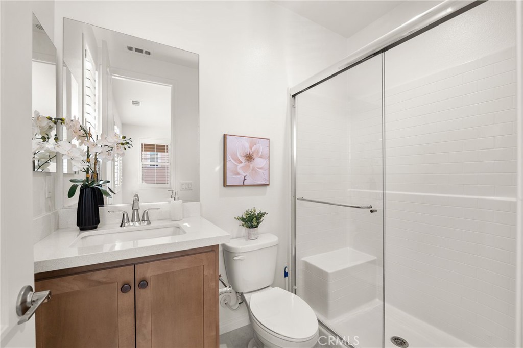 32448 Toyon Road Temecula, CA 92591 - Photo 37 of 72 a bathroom with a toilet a sink and a mirror