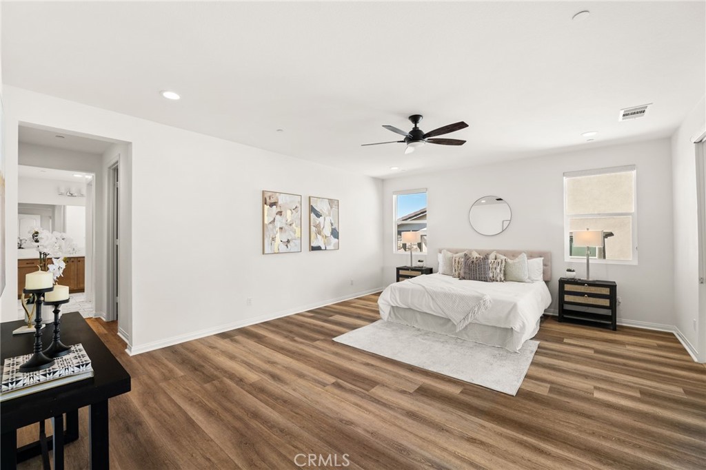 32448 Toyon Road Temecula, CA 92591 - Photo 42 of 72 a bedroom with a large bed and a chandelier