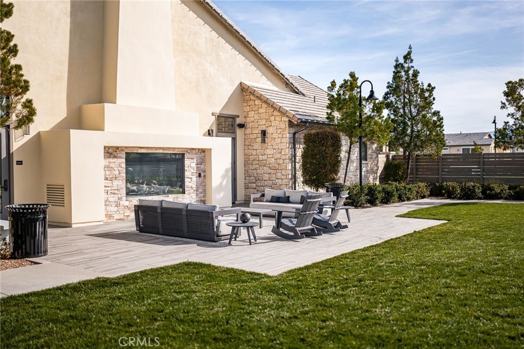 32448 Toyon Road Temecula, CA 92591 - Photo 69 of 72 a view of a patio with table and chairs with plants and wooden fence