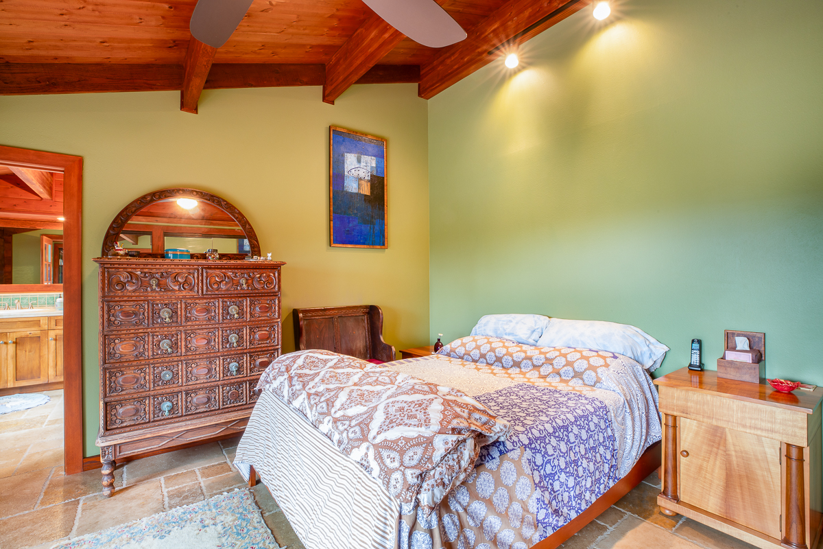 64-5097 White Road, Unit A Kamuela, HI 96743 - Photo 13 of 29 a bedroom with a bed and a lamp on the dresser