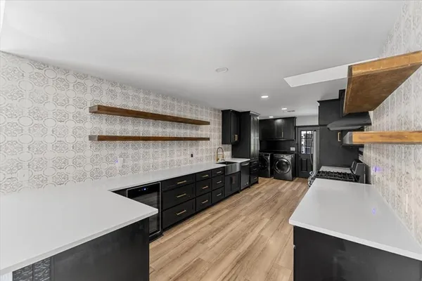 a kitchen with stainless steel appliances a sink a stove and a refrigerator