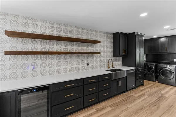 a kitchen with a sink a stove and cabinets