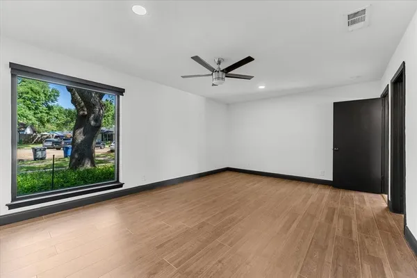 a view of a livingroom with a ceiling fan and window