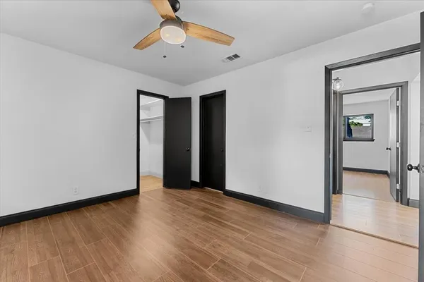 a view of a room with wooden floor