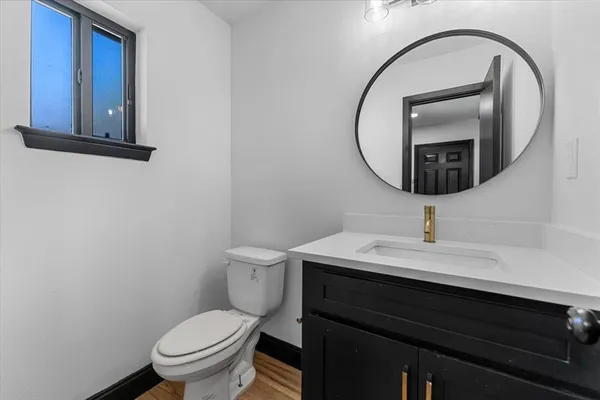 a bathroom with a toilet a sink and a mirror