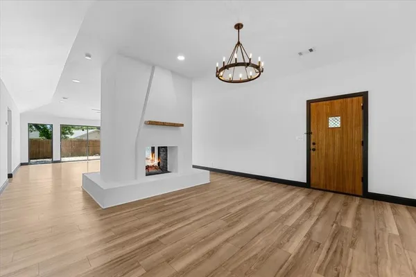a view of a room with wooden floor and window