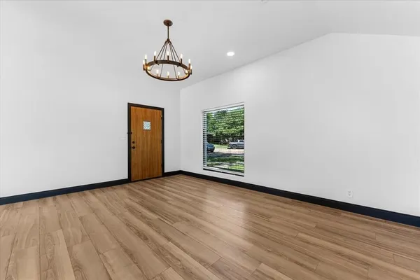 a view of a room with wooden floor and window