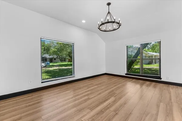 a view of a room with wooden floor fan and window