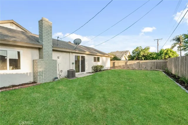 a front view of a house with a garden and plants