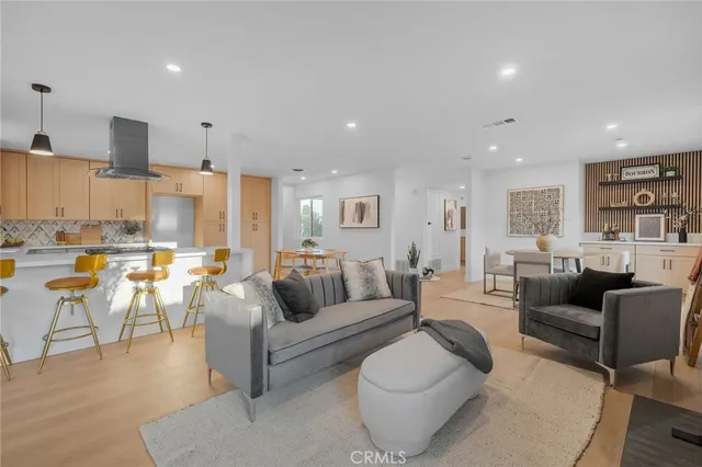 a living room with furniture kitchen and a table