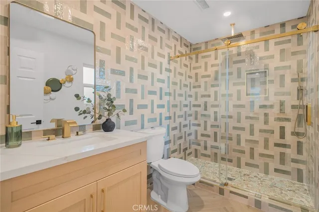 a bathroom with a sink a toilet and shower curtain