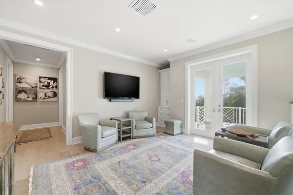 a bathroom with a sink and a flat screen tv