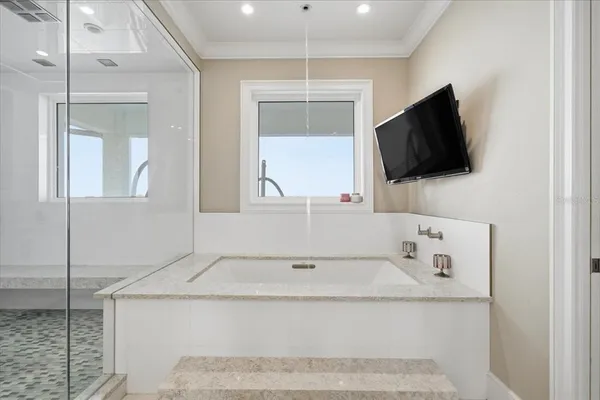 a bathroom with a double vanity sink toilet mirror and bathtub
