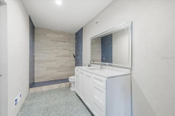 an aerial view of a houses with a lake and a building