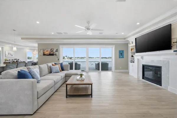 a living room with furniture and view of kitchen