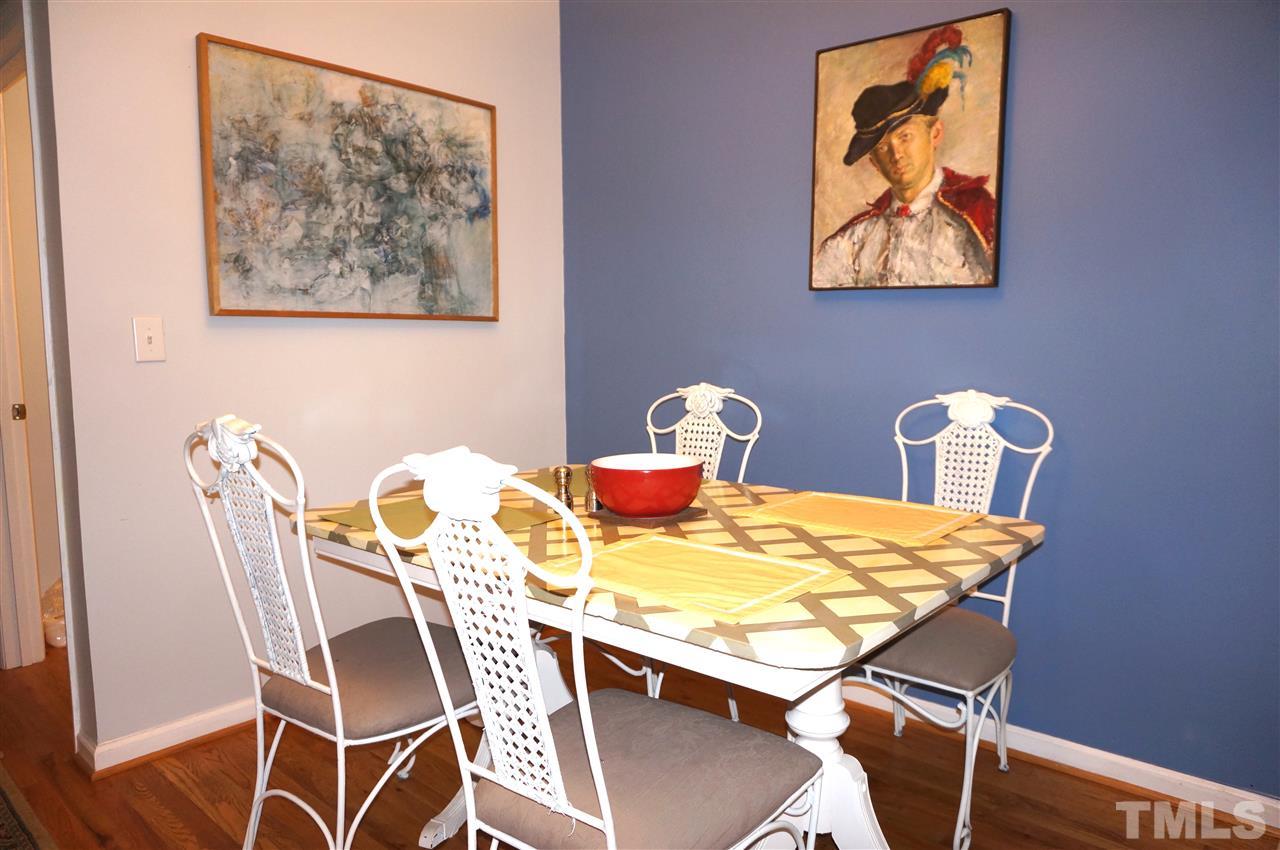 710 North Person Street, Unit 107 Raleigh, NC 27604 - Photo 12 of 21 a dining room with furniture and wooden floor