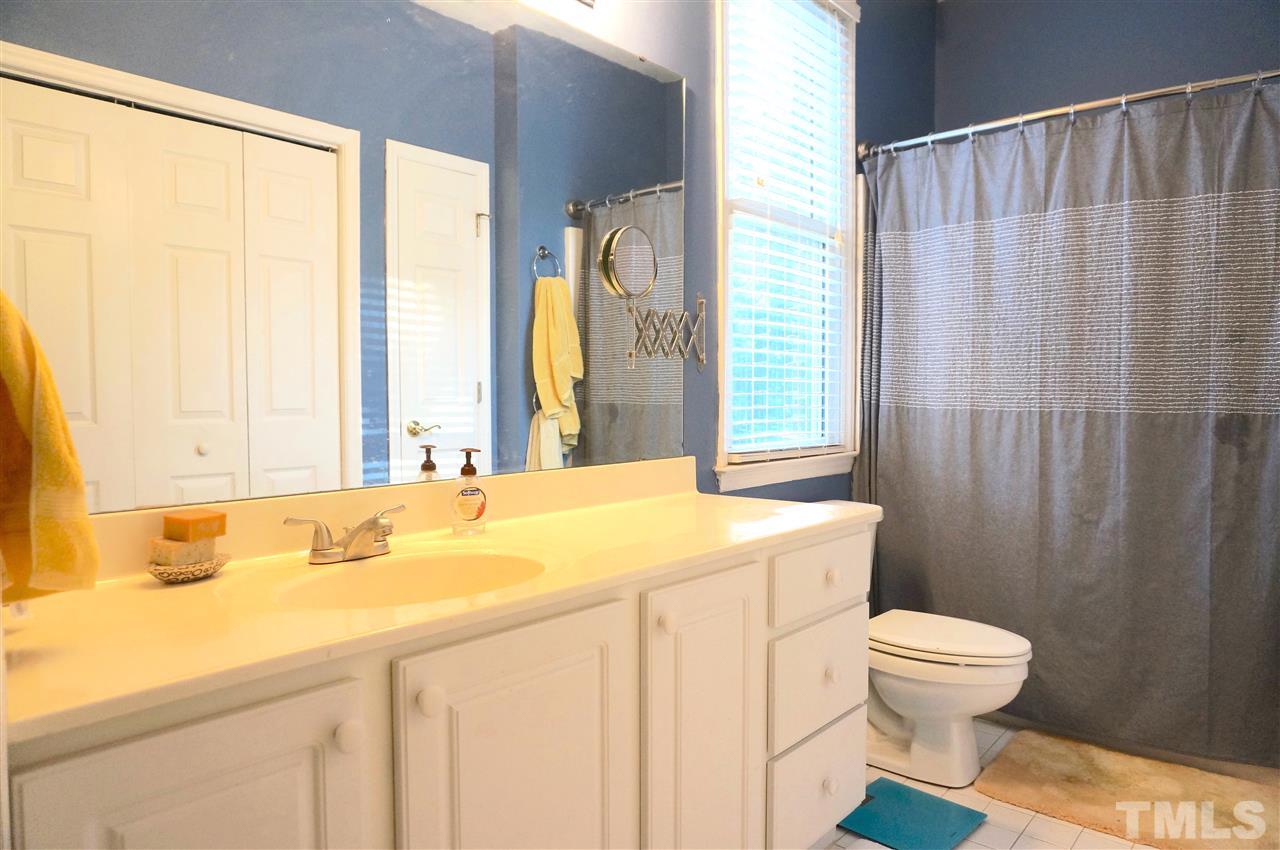 710 North Person Street, Unit 107 Raleigh, NC 27604 - Photo 18 of 21 a bathroom with a sink a toilet and a window