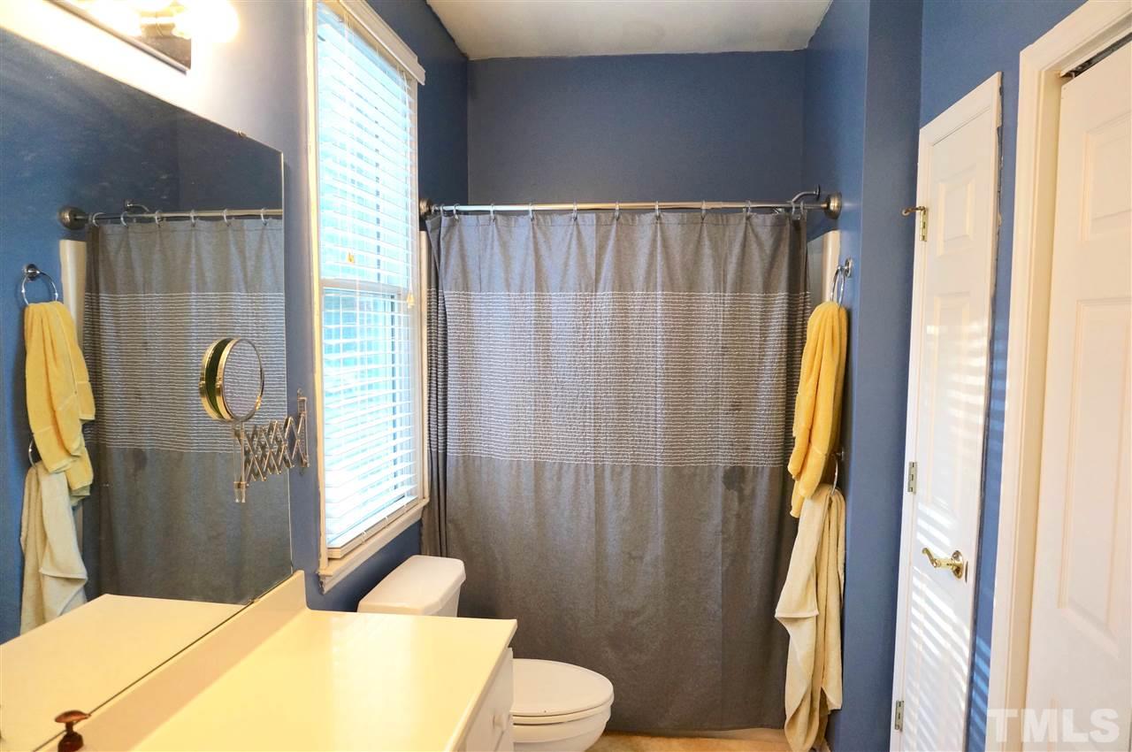 710 North Person Street, Unit 107 Raleigh, NC 27604 - Photo 19 of 21 a bathroom with a sink toilet and shower
