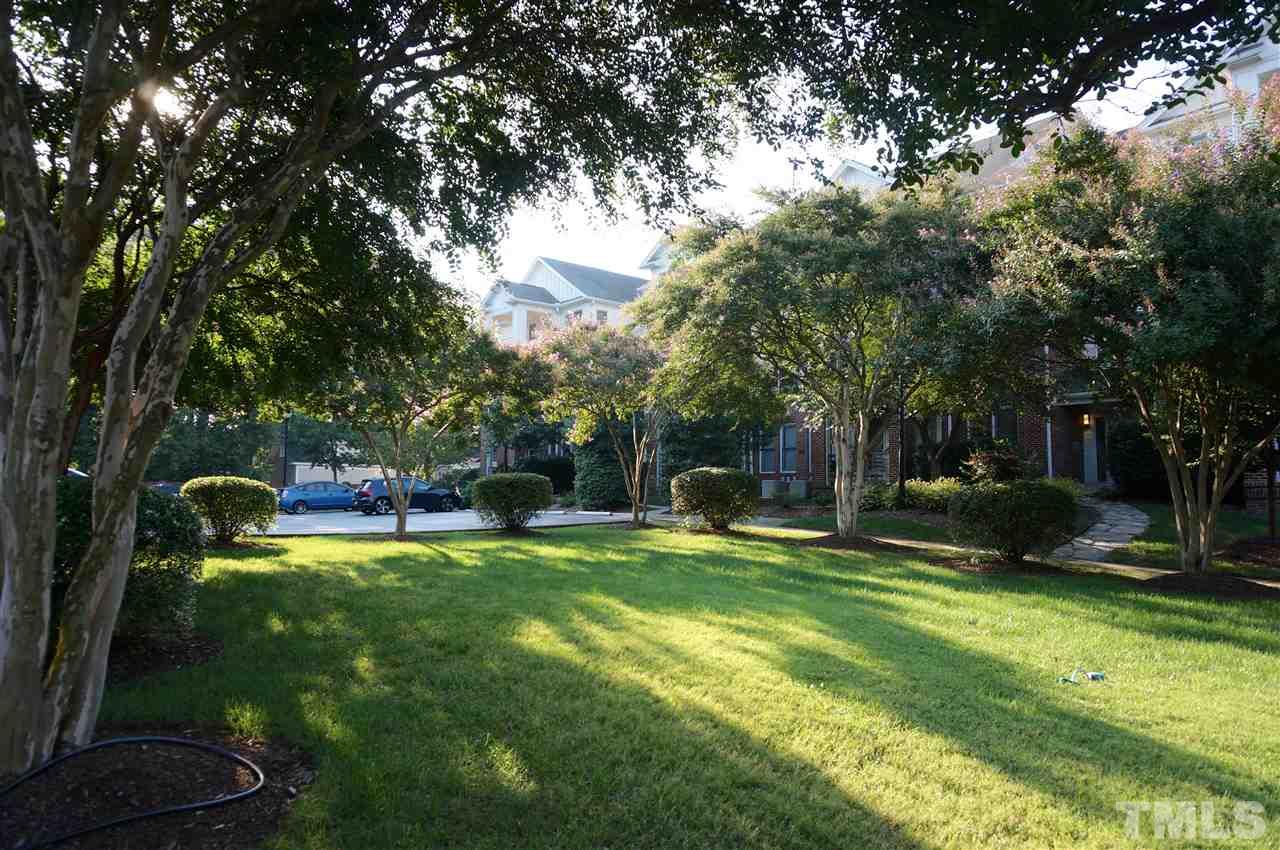 710 North Person Street, Unit 107 Raleigh, NC 27604 - Photo 20 of 21 a view of a swimming pool with a bench and trees