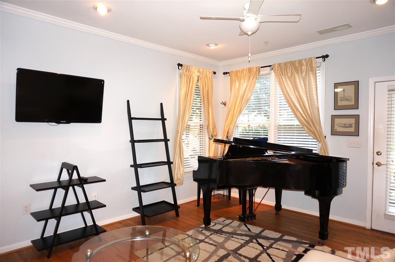 710 North Person Street, Unit 107 Raleigh, NC 27604 - Photo 8 of 21 a living room with furniture and a flat screen tv