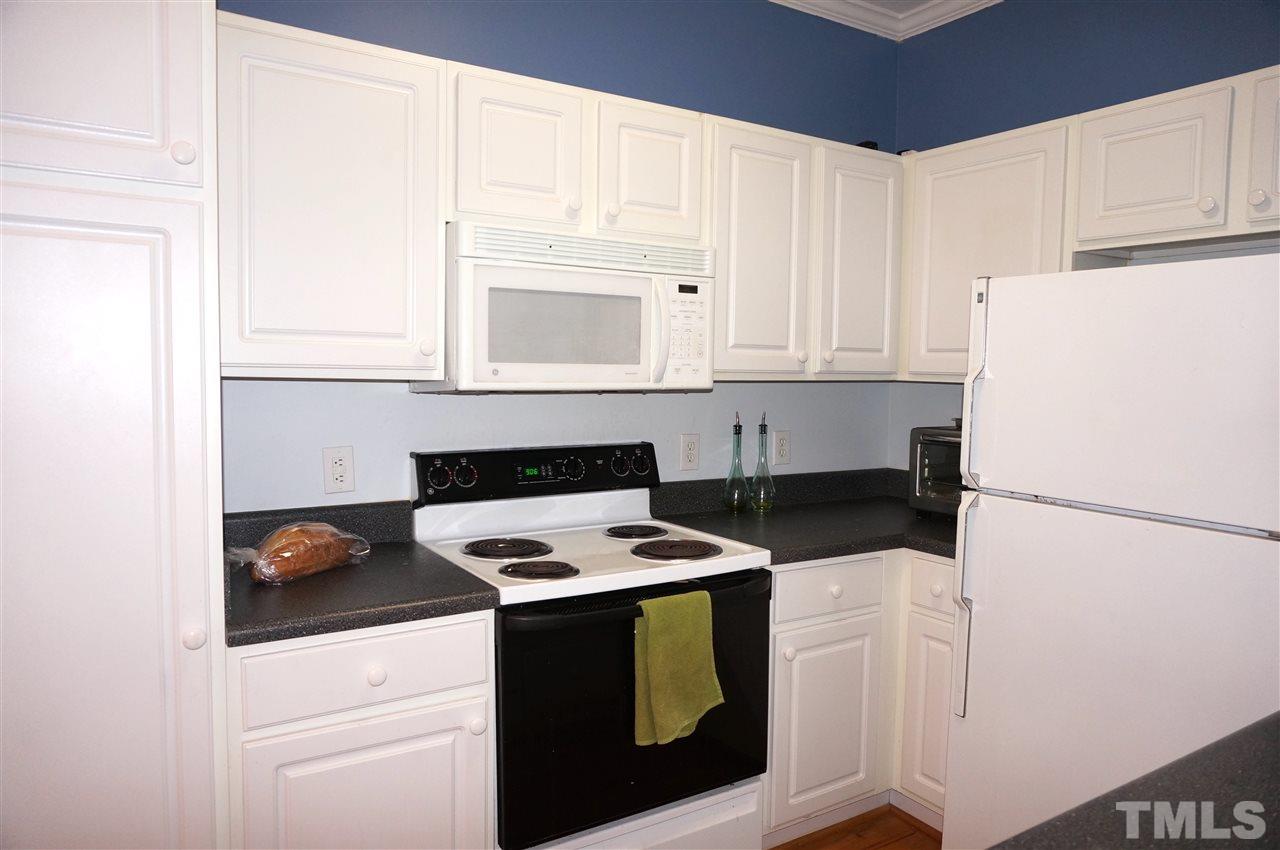 710 North Person Street, Unit 107 Raleigh, NC 27604 - Photo 9 of 21 a kitchen with appliances a sink and cabinets