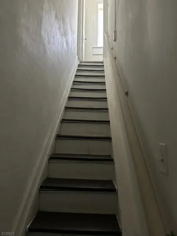 a kitchen with sink refrigerator and cabinets